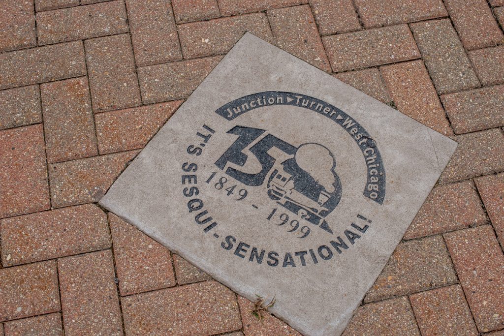 Photo of in-ground plaque commemorating West Chicago Sesquicentennial