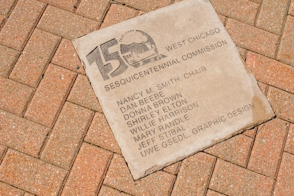 Photo of in-ground plaque commemorating West Chicago Sesquicentennial Commission