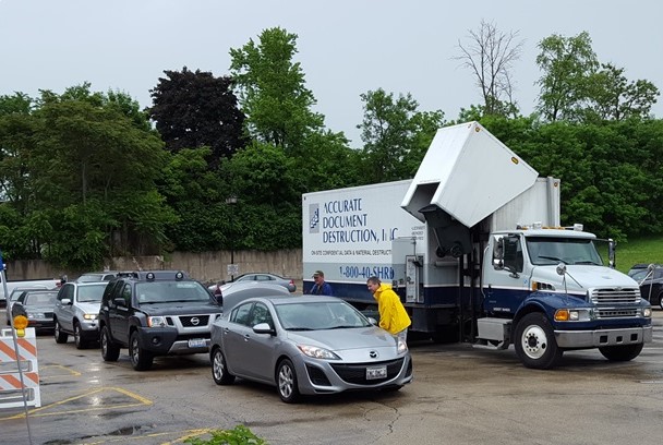 Cars lining up to document shredding truck