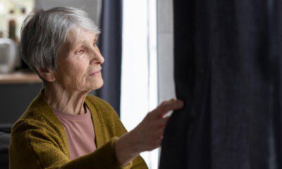 Senior looking out window